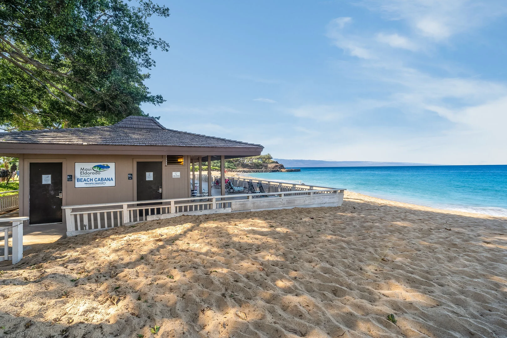 Maui Eldorado beach cabana and its ocean-facing deck beside the sandy beach